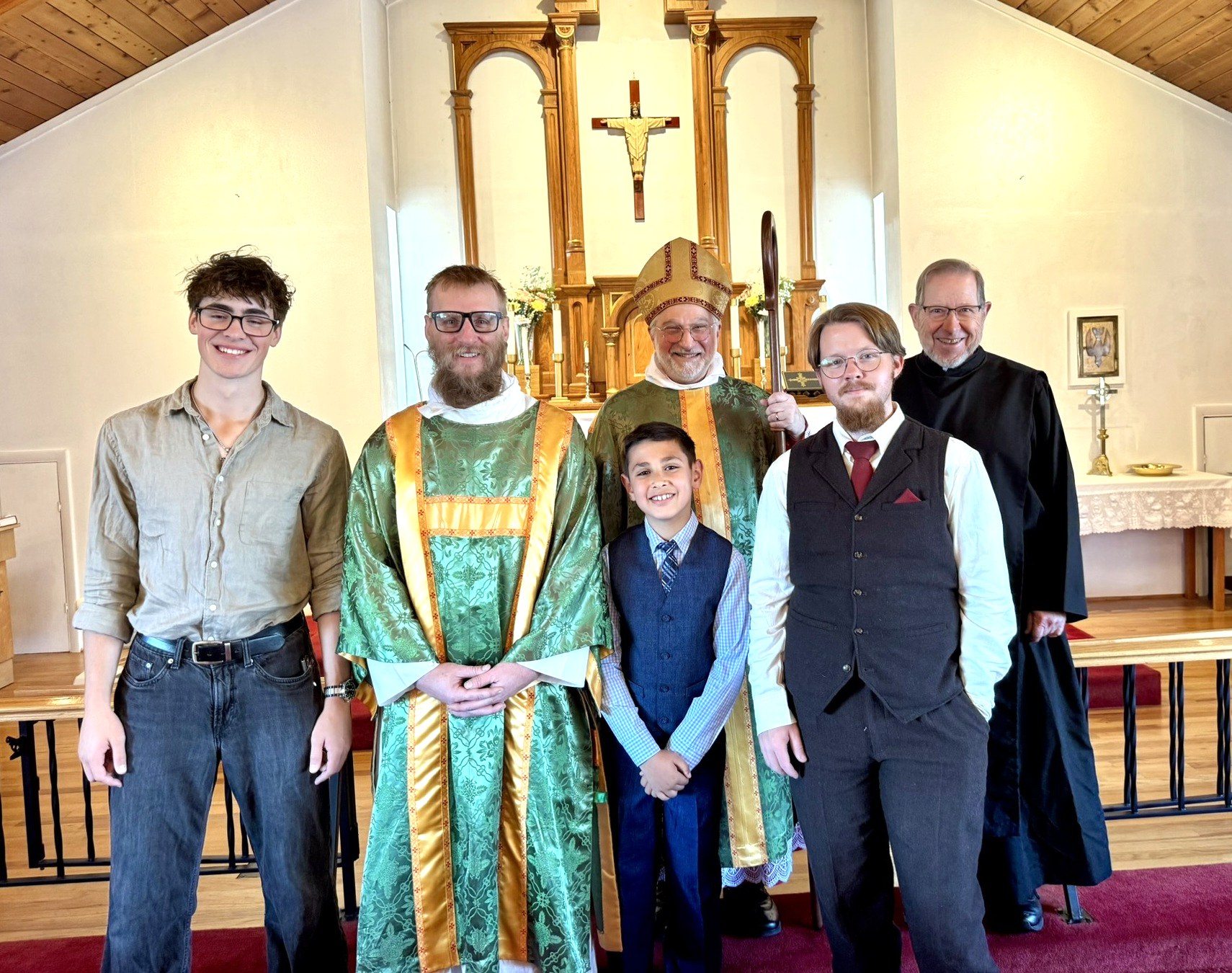 The newly confirmed with the new subdeacon, Bishop Fodor, and Fr. Nicholas Taylor before the altar after the service